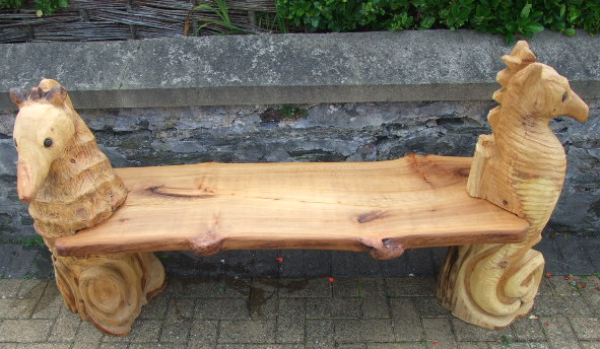 Wood slab bench with large wood carving seahorses 