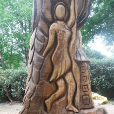 Fairy carved on a tree with a chainsaw
